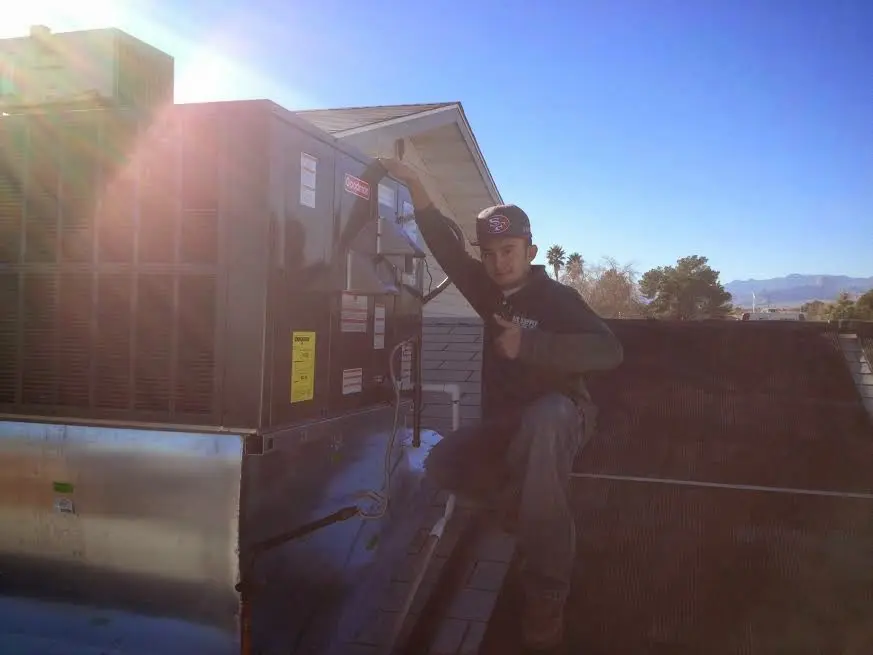 HVAC technician performing Boiler Repair on a rooftop unit in Wolf Trap